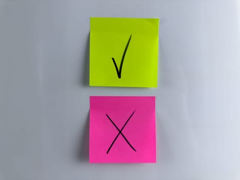 Choice concept, tick or cross the required answer. Choice symbols for management decision making project. Tick and cross written with marker on sticky note