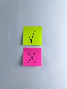 Answer choice symbol with check mark and cross on sticky note. Making management decision in company and marking an important choice with special symbols