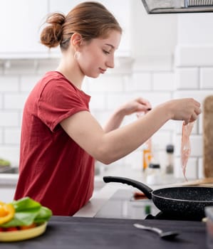 Sweet Girl Cooks Bacon In The Kitchen At Home
