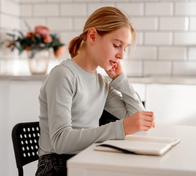 Cute Little Girl Doing Homework At Home