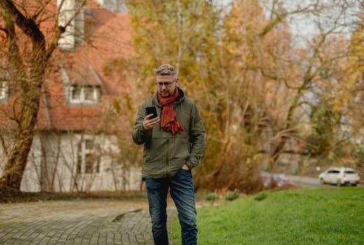 Young, Attractive Man On A Street Using Smartphone