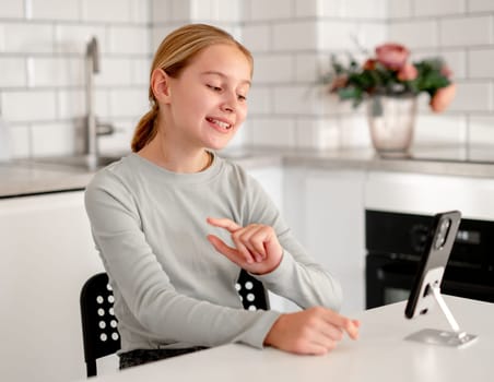 Cute Little Girl Talks Via Video Call Online Using A Smartphone With Grandparents