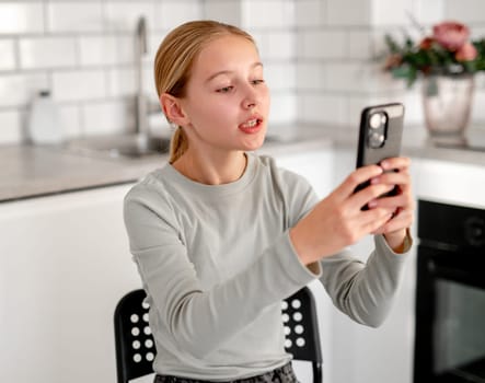 Cute Little Girl At Home Talking Via Video Call Online Using A Smartphone