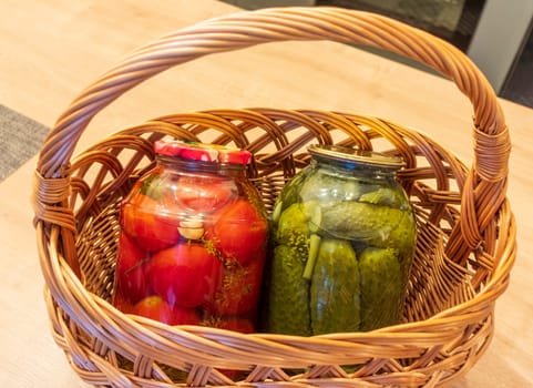 Jars with different types of pickles and preserves in a wicker basket