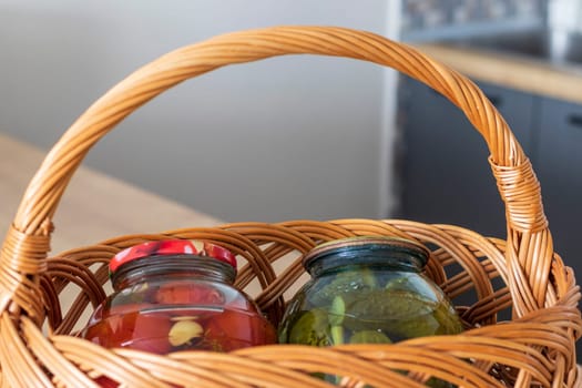 Jars with different types of pickles and preserves in a wicker basket
