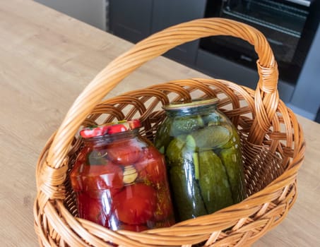 Jars with different types of pickles and preserves in a wicker basket