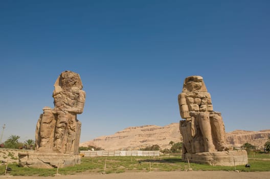 Twin statues of Colossi of Memnon, Luxor, Egypt. Theban necropolis
