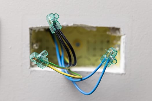 Close up electrical wires being connected using terminal block connectors 