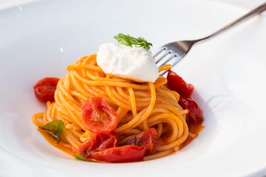 Italian pasta - spaghetti with mozzarella cheese closeup, mediterranean diet