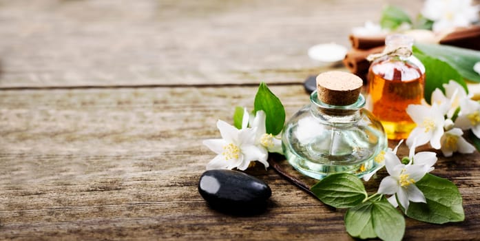 Aromatherapy with essential and massage organic oil handmade with jasmine, cinnamon and vanilla. Wellness center design background. Spa treatment product.