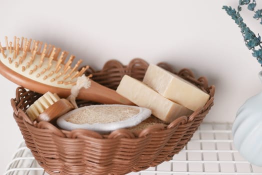 Various skincare items including soap, a brush, and a scrub sit neatly arranged.