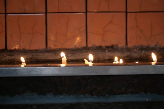 Soft candlelight illuminates a ledge in a tranquil atmosphere.