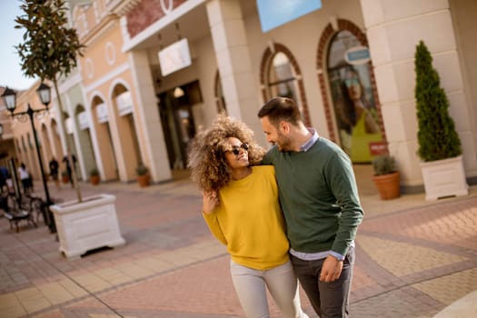 Lovely young multiethnic couple walking on the street