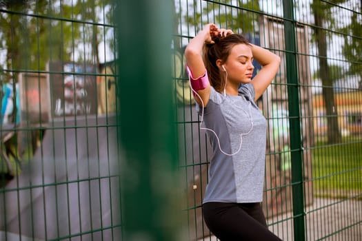 Pretty young woman having exercise outdoors