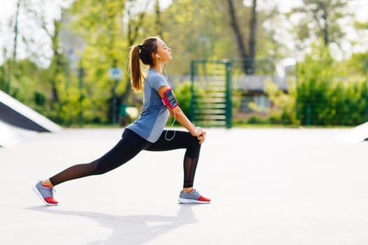 Pretty young woman having exercise in the park on a sunny day