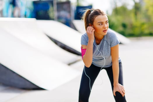 Pretty young woman having exercise in the park on a sunny day