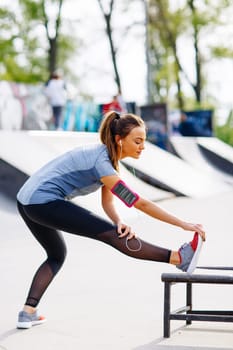 Pretty young woman having exercise in the park on a sunny day
