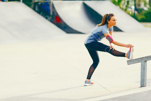 Pretty young woman have training outdoors on a sunny day
