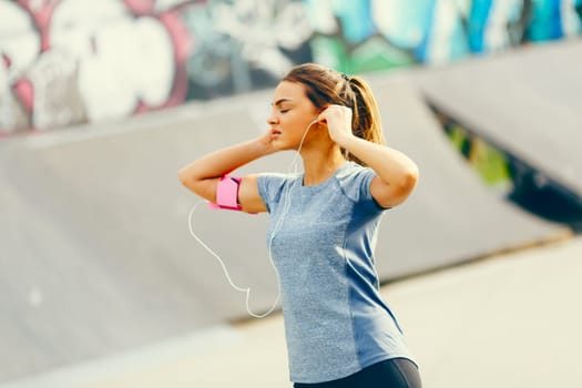 Pretty young woman having exercise outdoors