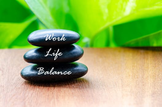 Work Life Balance text on black zen stones. Life balance concept.