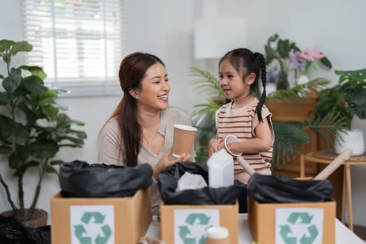 The mother teaches her daughter about recycling, transforming ordinary paper cups into part of a fun creative project, underscoring the importance of sustainability.