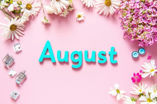 Bright blue letters spelling August are surrounded by an assortment of colorful flowers and decorative pieces on a soft pink background, creating a festive and cheerful atmosphere.