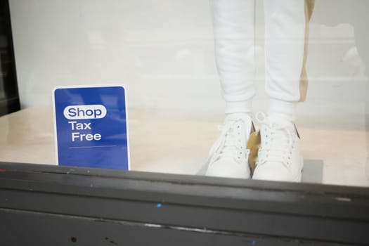 Shop offering tax free shopping features white sneakers displayed prominently.