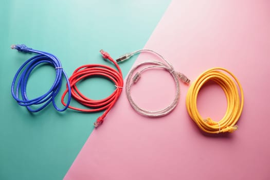 Brightly colored cables are neatly laid out on two-tone pastel surfaces.