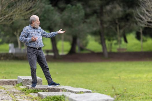 Elderly man performing tai chi exercises in a peaceful park setting, promoting health and wellness in old age