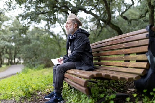 Elderly writer composing in peaceful park setting, enjoying tranquility and inspiration