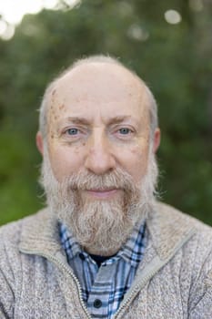 Cheerful retired man enjoying peaceful nature, showcasing healthy aging and wisdom