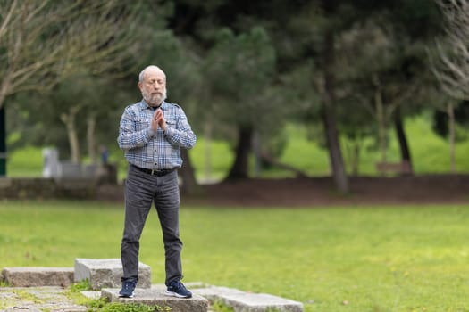 Elderly man practicing mindfulness in nature, promoting wellness and tranquility during retirement