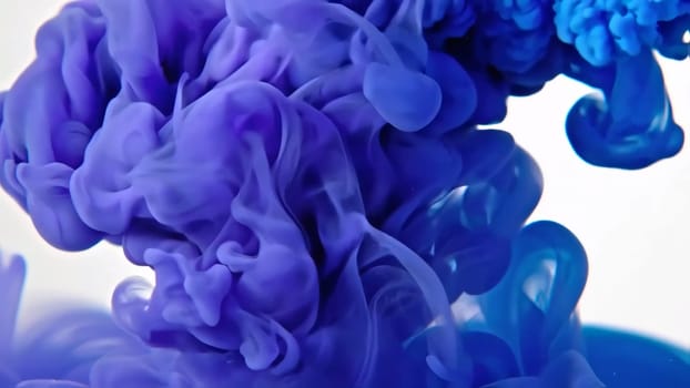 Swirling deep blue ink merges with liquid paint, creating an abstract backdrop that illustrates the beauty of flowing ink. The fluid movement captures the essence of color in a captivating way.