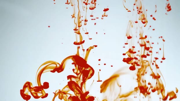 Vivid colors blend and flow gracefully, showcasing liquid paint moving and dripping through an ink liquid backdrop.