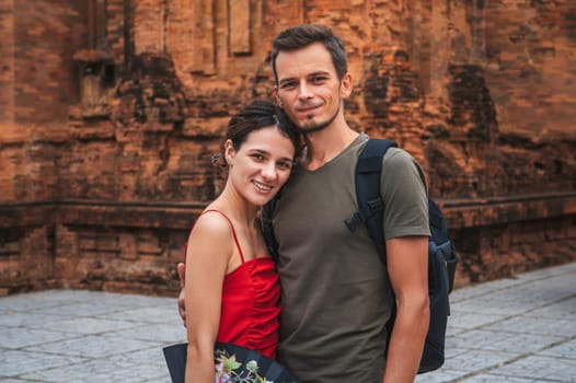 happy adult couple of tourists in love at ancient famous landmark of the Cham Towers of Po Nagar in Nha Trang in Vietnam in Asia