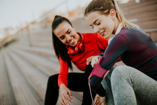 Beautiful women relaxing after a long run in the city  and have fun