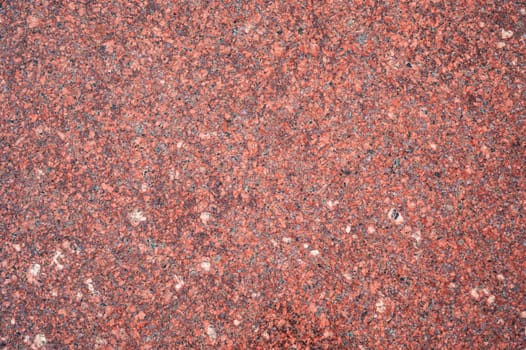 background with red granite tile texture. The texture of natural granite stone for the decoration of facades and sidewalks