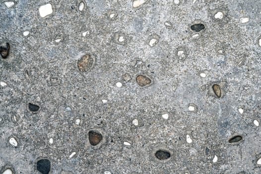 texture of gray asphalt with stones. Sidewalk background