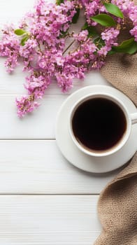Enjoying a hot cup of coffee with beautiful pink flowers on a rustic white wooden table