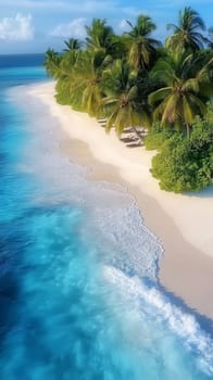 Breathtaking aerial view of turquoise ocean waves crashing on a pristine white sand beach lined with palm trees and sunbeds in the maldives