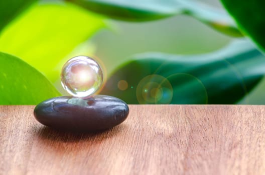 Black Zen stone with customizable space for text or message. Shining glass marble background.