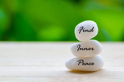 Find Inner Peace text on the white Zen stones. Inner peace concept.