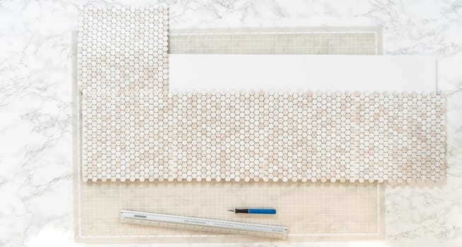 In the process of mounting peel and stick mosaic tiles onto a foam board, perfect for enhancing a food photography studio's aesthetic.