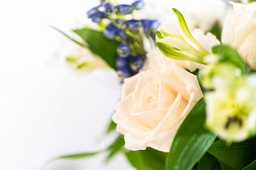 A stunning bouquet featuring fresh white roses and assorted flowers gracefully arranged in a vase, exuding timeless beauty.