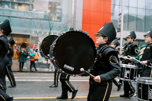 A lively marching band performs energetically at a city parade, mesmerizing all