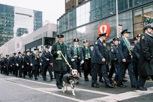 Officers march in unity, showcasing their dedication and service alongside a dog