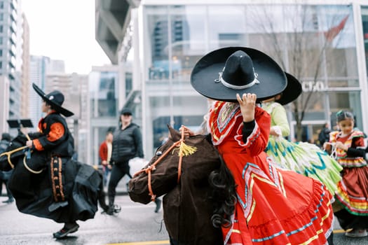The colorful costumes of performers created a festive atmosphere during the parade