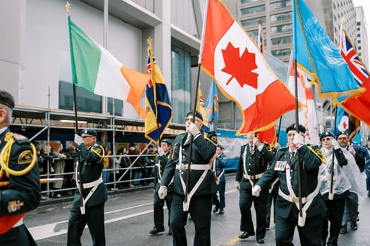Flags wave proudly during a vibrant city parade celebration filled with joy