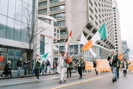 Festive demonstration featuring diverse flags and engaged participants.