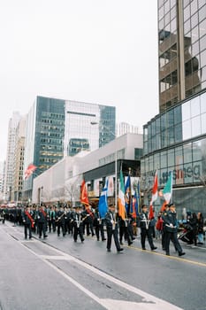 A lively parade showcasing colorful flags and enthusiastic participants in the city